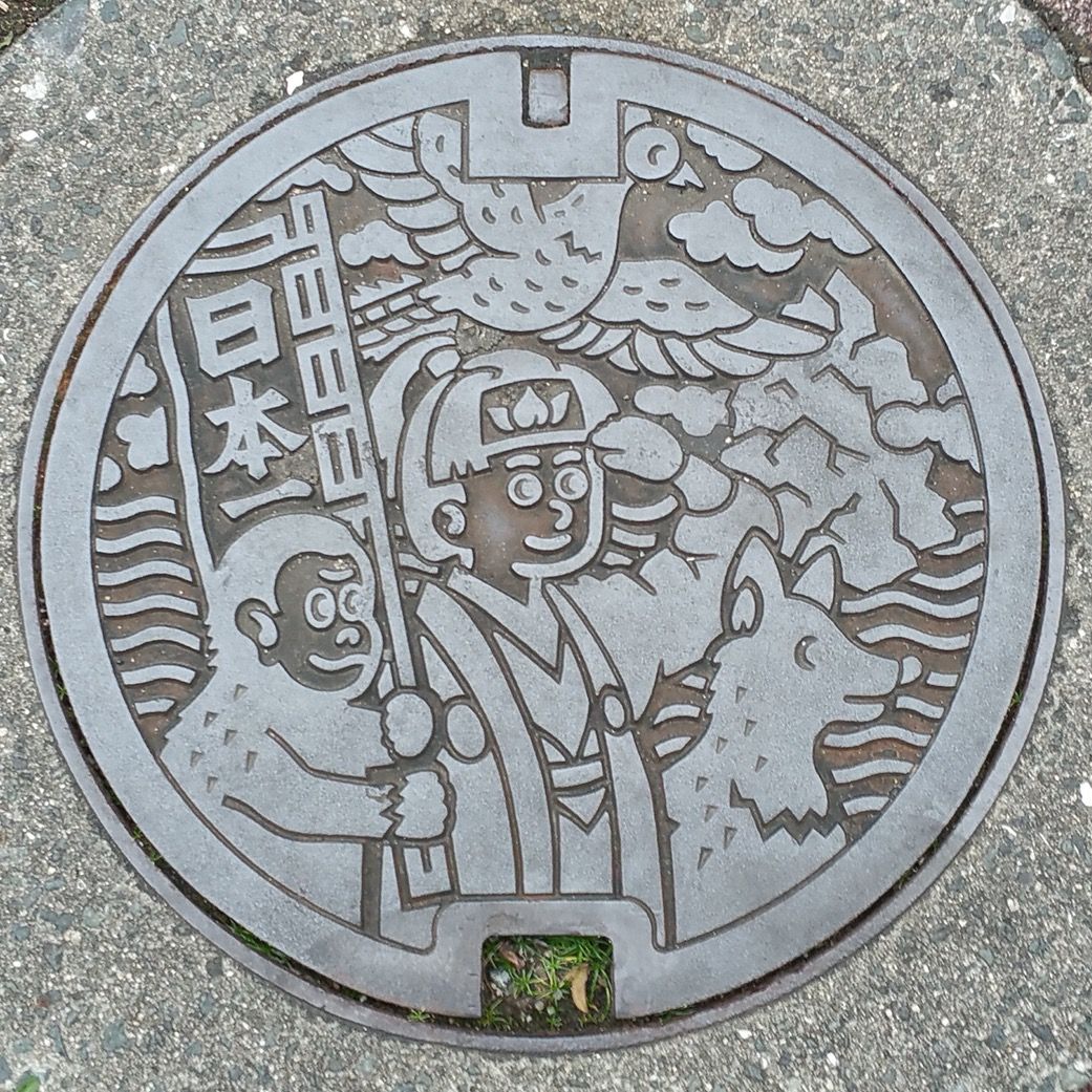 A manhole cover with Momotaro-san - the Little Peach Boy, much beloved folk hero of Okayama, Japan.