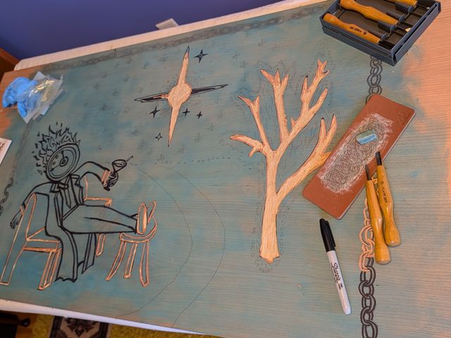 2'x3' board with a design drawn in sharpie, wish some parts carved. Also carving tools and honing strap.