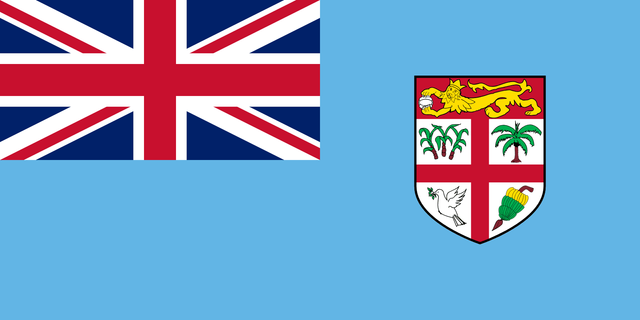 Flag with light blue field, Union Jack in the canton, and a coat of arms in the fly featuring sugar cane, a palm, a dove, and bananas