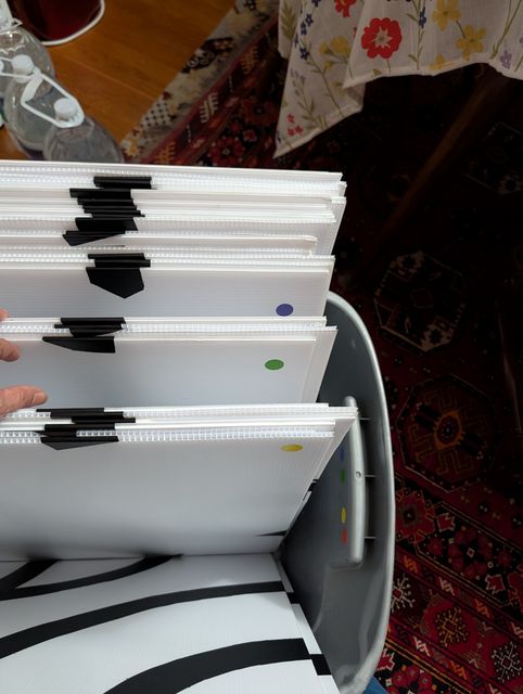 Back of large tiles, showing colored dots as markers. Matching dots are on the small tiles. There are about 6 tiles of each color, so should be quick to pull the correct one.