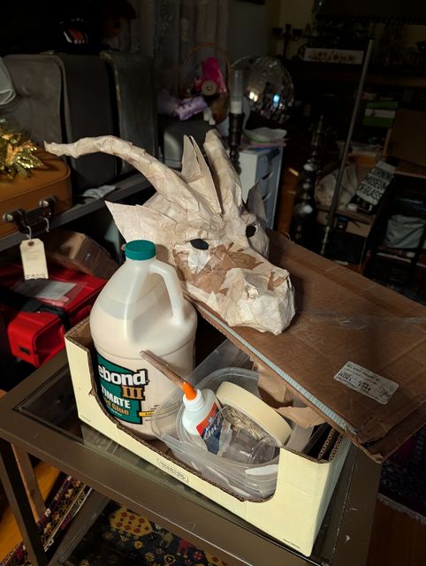 Paper mache dragon head, and mache supplies.